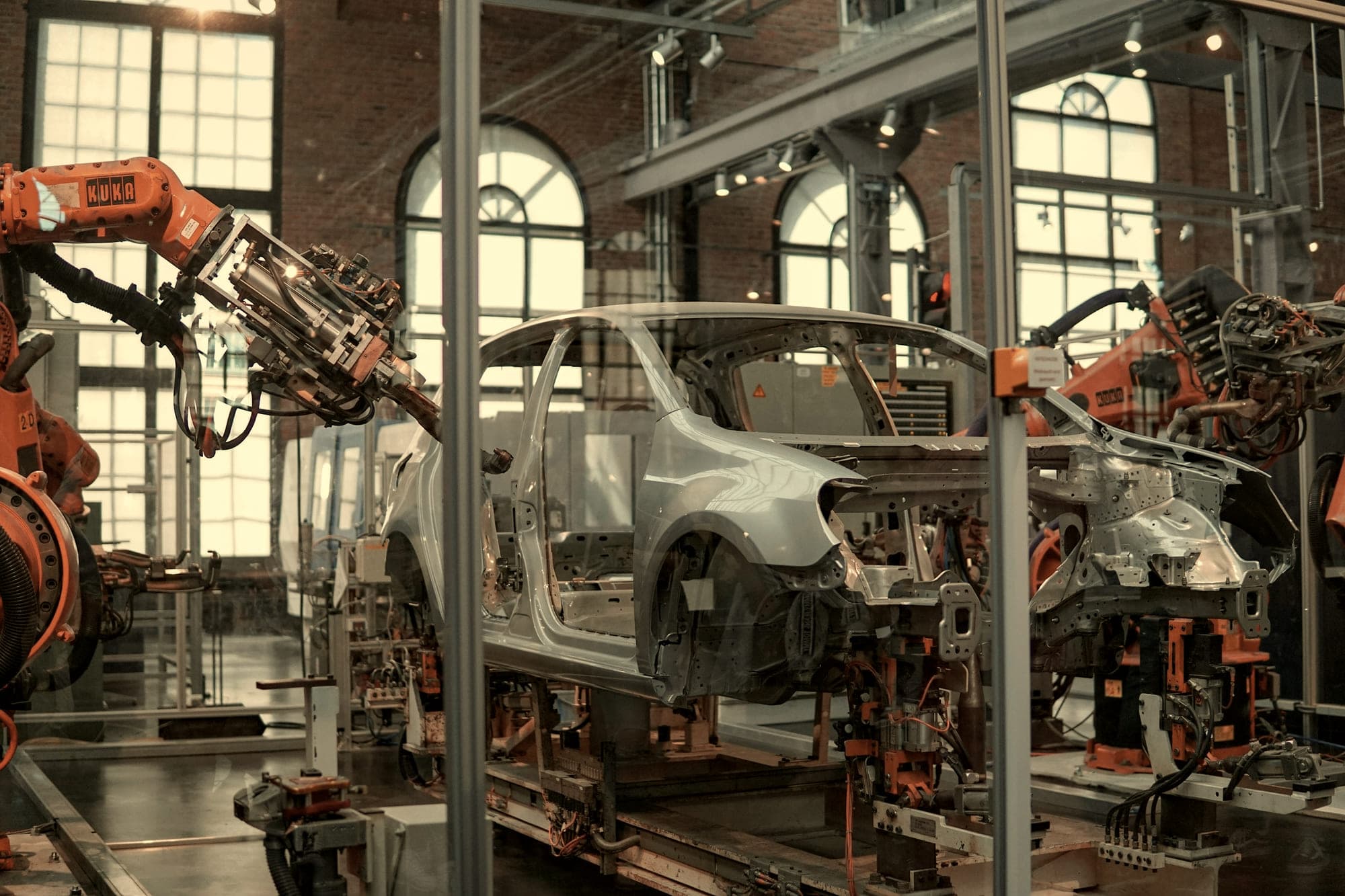 A production hall with overhead structure and machinery in low light
