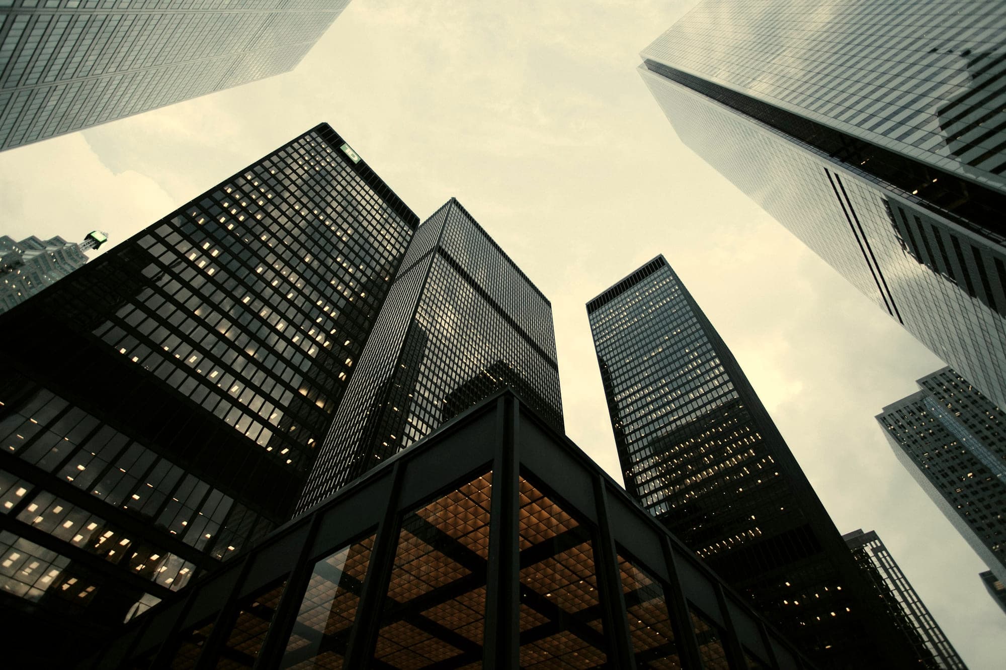 Towers seen from street level, converging against a bright sky
